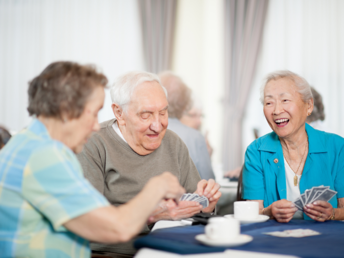 ouderen lachen en drinken samen koffie