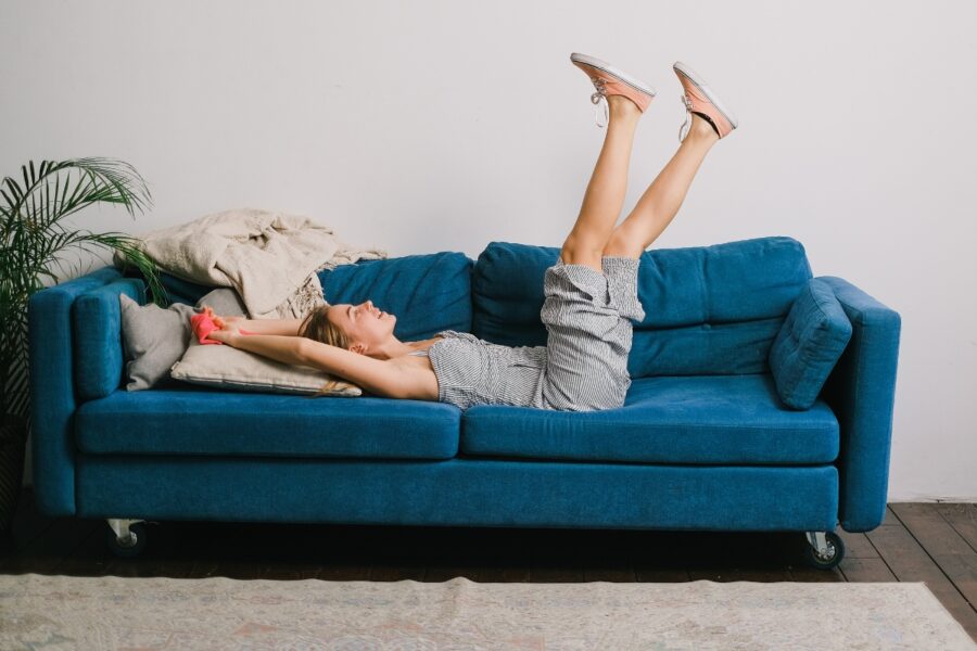 Vrouw ligt te relaxen op een bank.